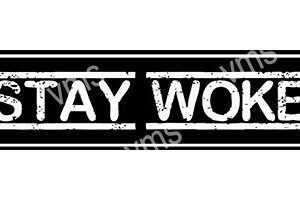 Black and white sign with 'STAY WOKE' text in distressed font.
