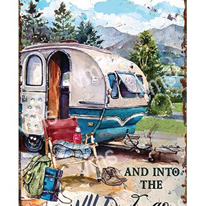 Vintage camper trailer parked in a scenic mountain setting with camping gear.