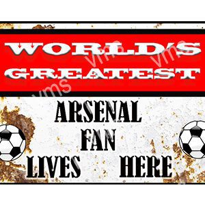 Sign stating 'World's Greatest Arsenal Fan Lives Here' with soccer ball graphics.