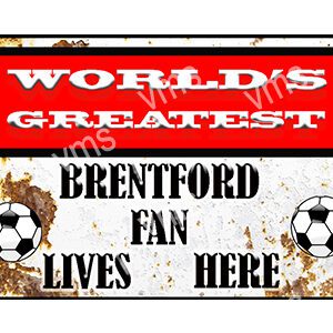 A vintage sign saying "World's Greatest Brentford Fan Lives Here" with a soccer ball.