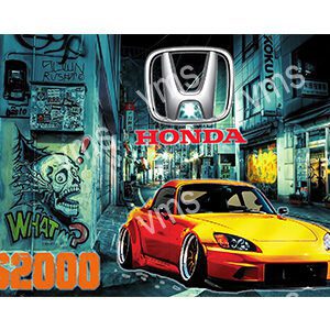 A customized yellow and red Honda car in an urban setting at night.