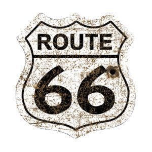 Vintage Route 66 road sign with rust and wear.