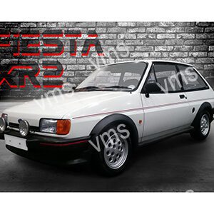 Classic white Toyota AE86 hatchback parked indoors against a brick wall.