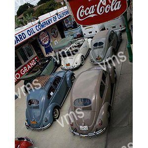 Vintage cars lined up at a classic car event under Coca-Cola signage.