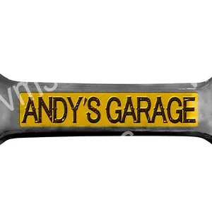 A wrench with 'ANDY'S GARAGE' engraved on it.