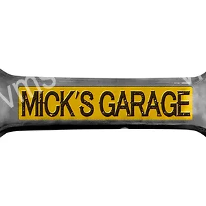 A yellow and black wrench with 'MICK'S GARAGE' written on it.