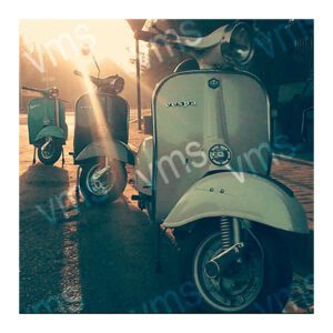 Vintage scooters parked together in a dimly lit area.
