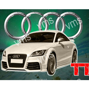 A sleek white Audi coupe with four chrome rings in the background.