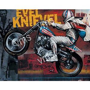 A motorcyclist performing a wheelie in front of a graffiti wall.