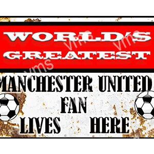 A worn sign declaring a Manchester United fan lives here with a soccer ball graphic.