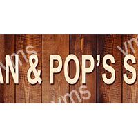 Wooden sign reading 'Gran & Pop's' with rustic background.