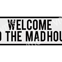 A black and white sign saying 'WELCOME TO THE MADHOUSE'.