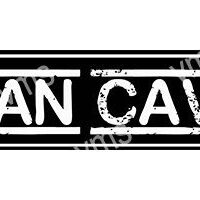 A black and white rectangular sign reading 'MAN CAVE'.
