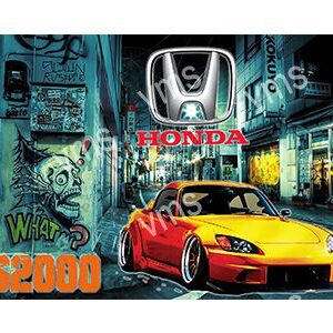 A customized yellow and red Honda car in an urban setting at night.
