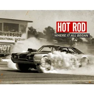 Classic hot rod car burning rubber on the street.