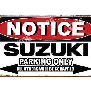 A bold Suzuki parking only sign with a warning about scrapping other vehicles.