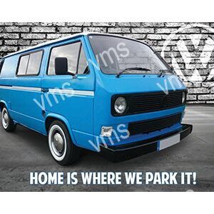 Blue vintage van parked against a graffiti wall with humorous text.