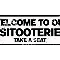 A black and white sign saying 'Welcome to our Sitooterie, Take a Seat'.