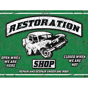 Vintage car restoration shop sign with skull and wrench logo.