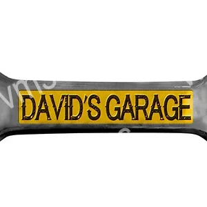 A wrench with 'DAVID'S GARAGE' engraved on it in yellow.