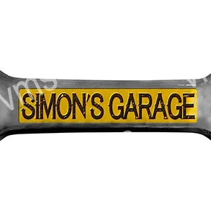 A yellow and black garage sign reading 'SIMON'S GARAGE'.