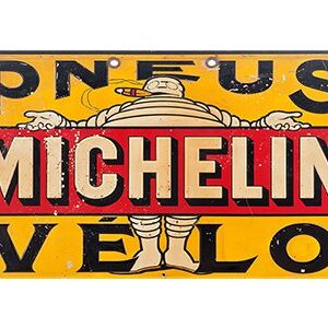 Vintage Michelin advertisement featuring the Michelin Man and bold text.